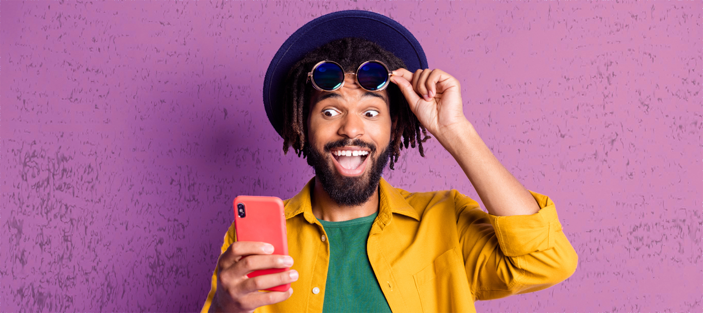 Photo of impressed funny dark skin guy hand touch sunglass look phone like subscribe isolated on violet color background