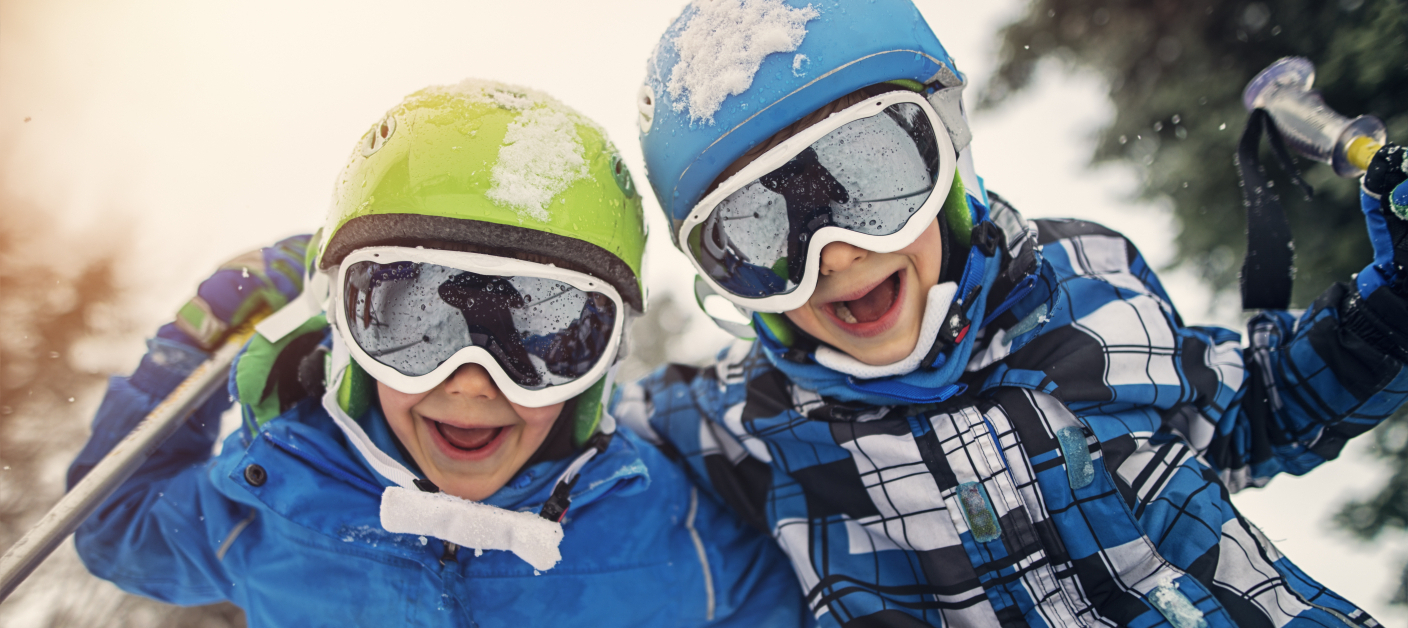 Portrait of little skiers  laughing at the camera