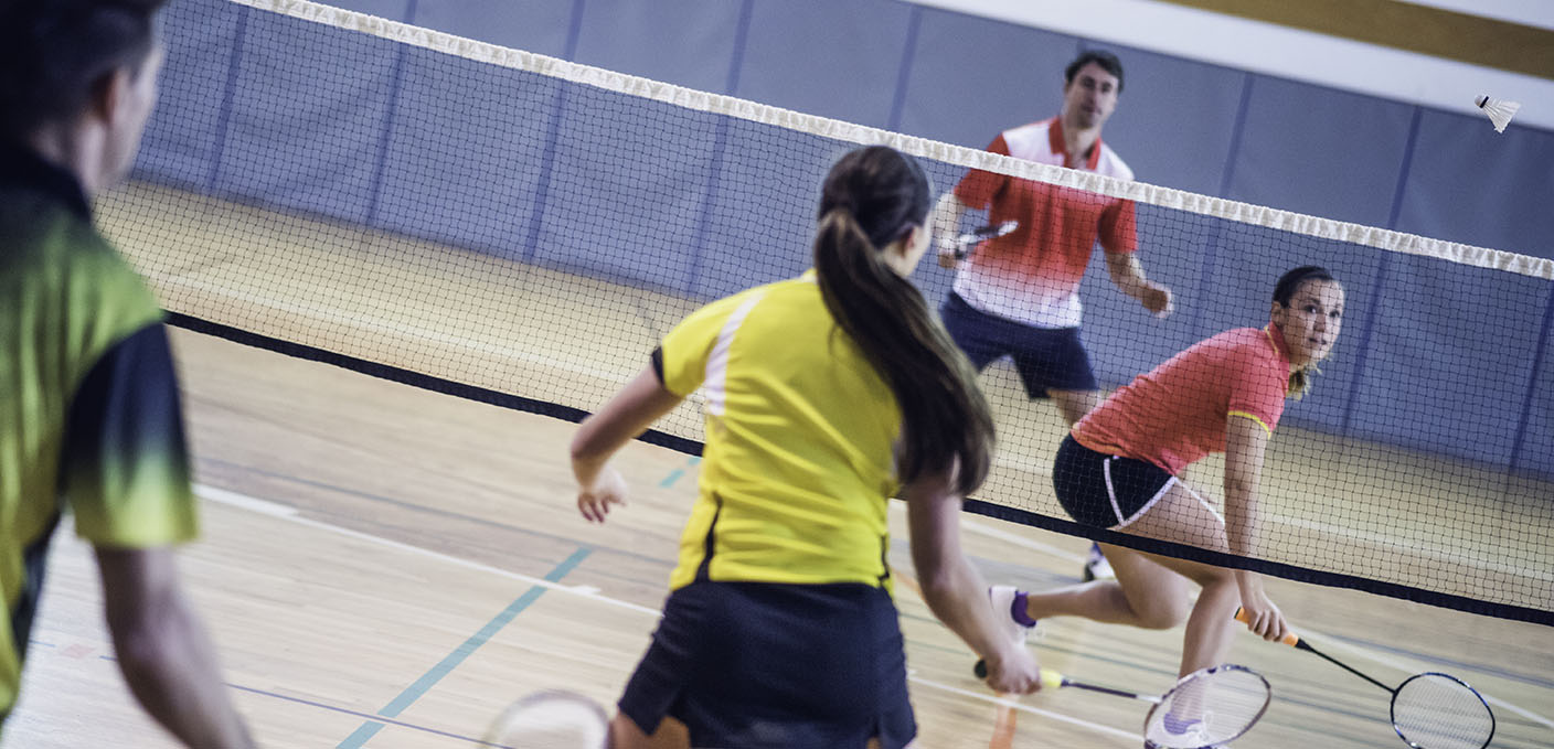 Two couples playing badminton